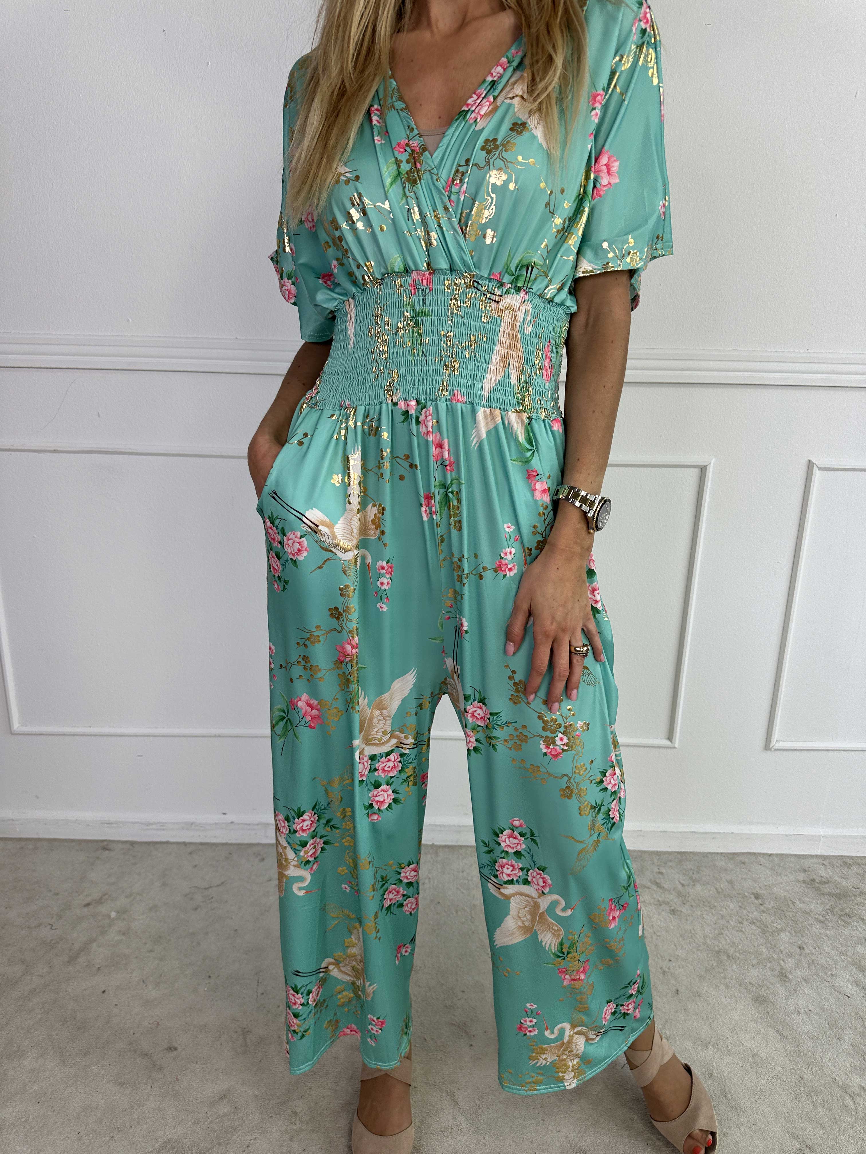Pams Fly Jumpsuit - Elastisk byxdress med blommor- och fågelmönster